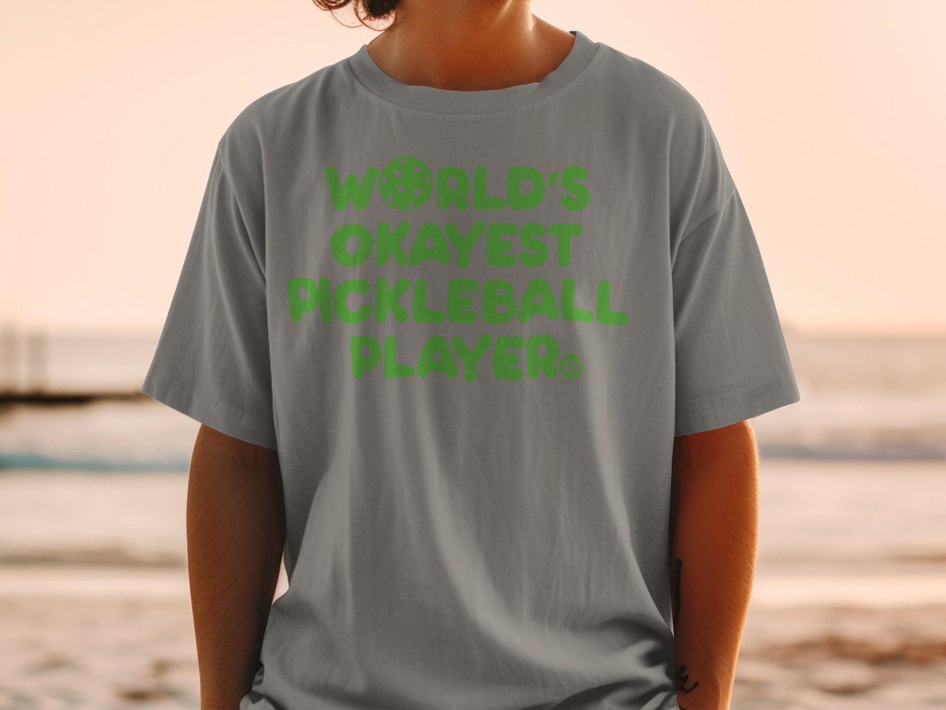 Gray t-shirt with "World's Okayest Pickleball Player" text in lime green.