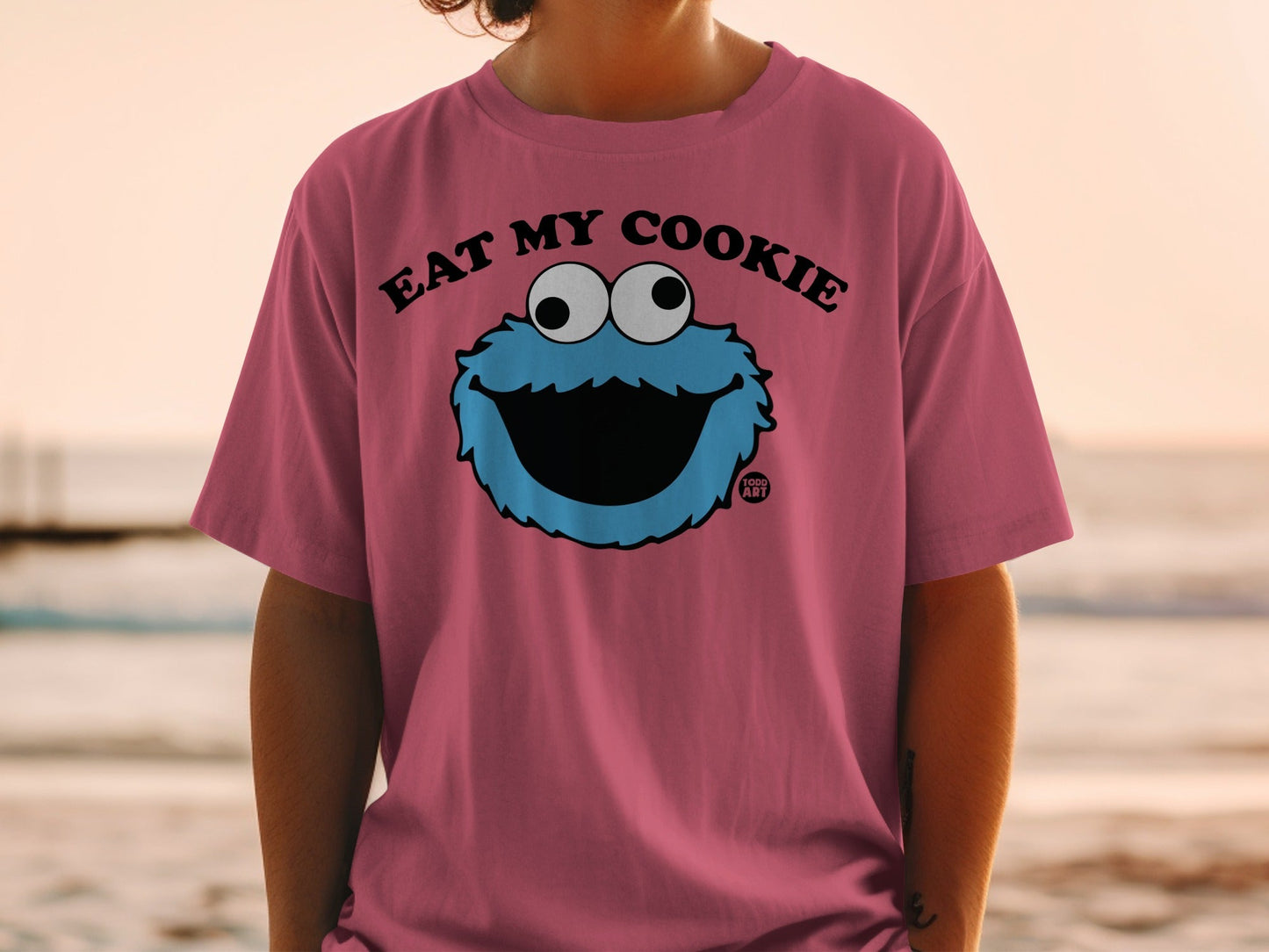 Pink t-shirt with Cookie Monster's face and "EAT MY COOKIE" text.