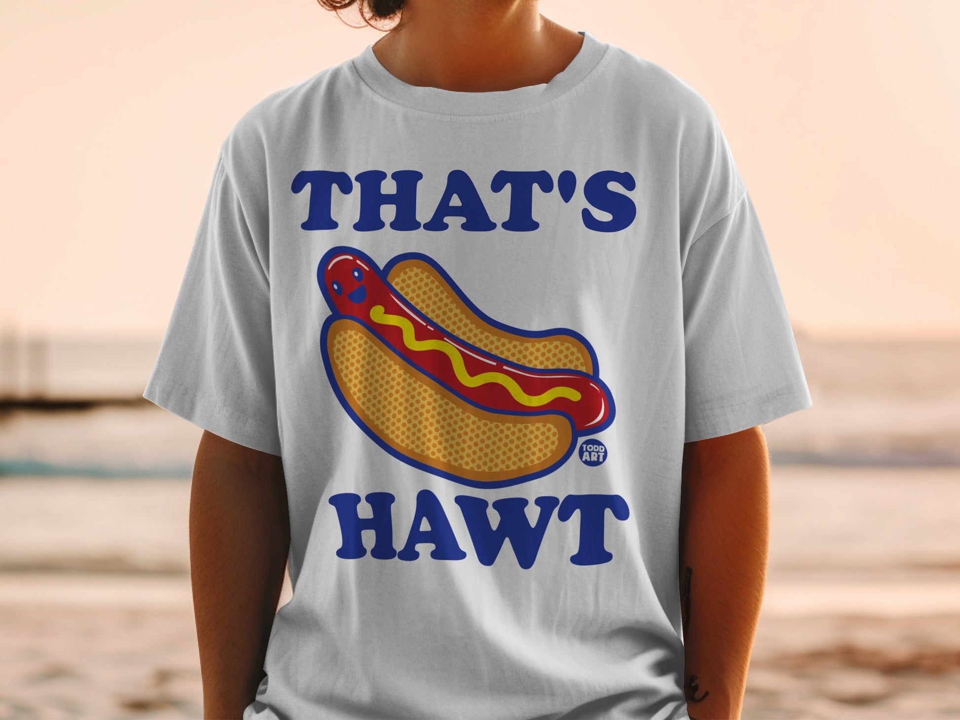White t-shirt with a smiling hot dog and "THAT'S HAWT" text.