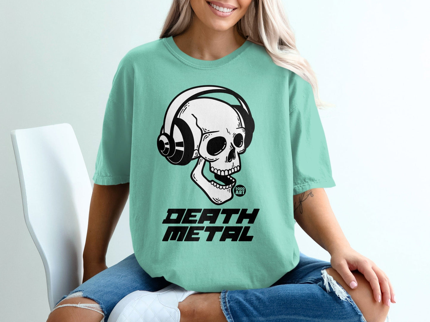 Teal t-shirt with skull wearing headphones and "DEATH METAL" text.