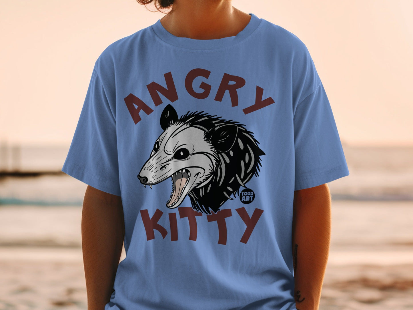 Blue t-shirt featuring a cartoon opossum with "ANGRY KITTY" text.