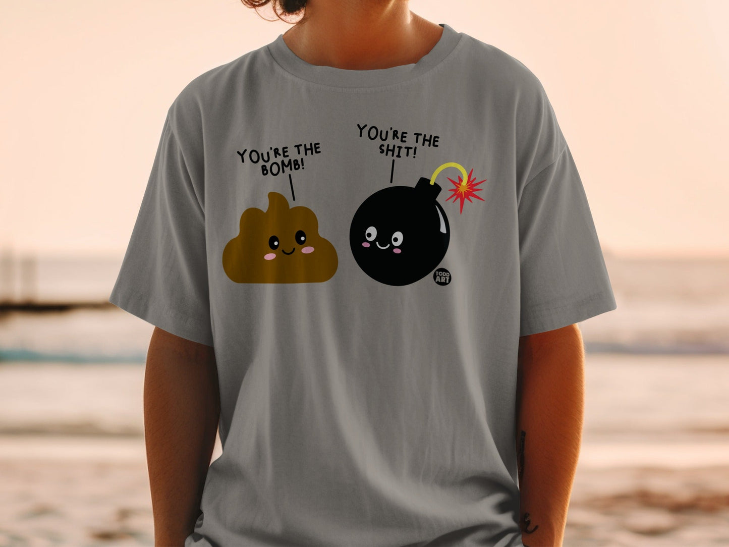 Poop and bomb characters on a gray t-shirt saying "You're the bomb!"