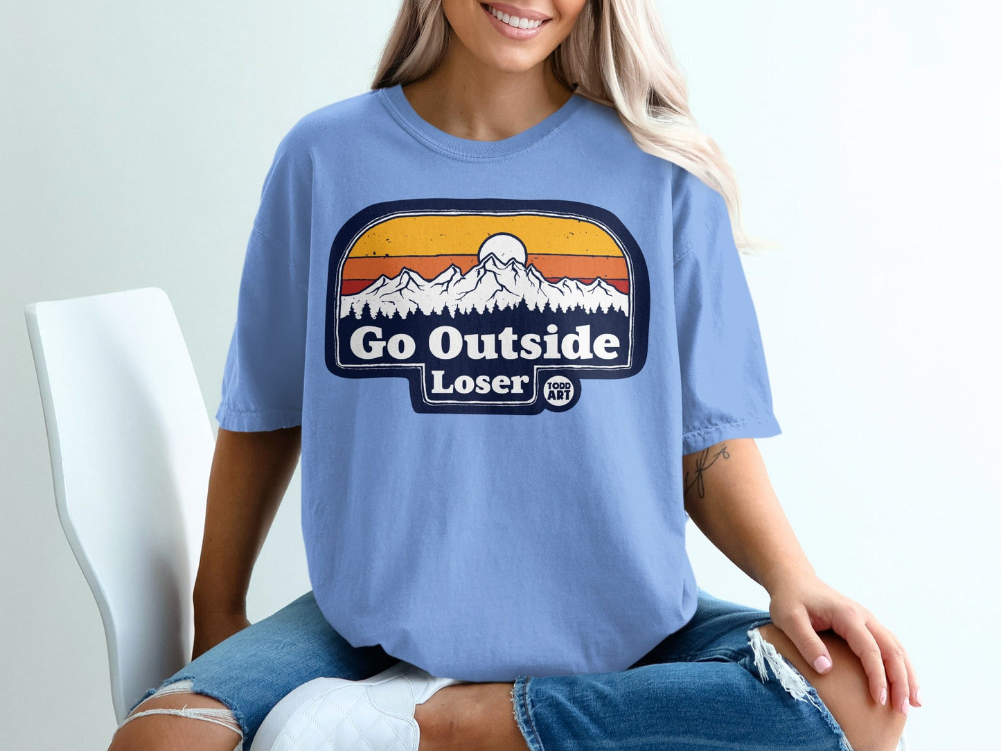 Light blue t-shirt with "Go Outside Loser" mountain sunset graphic.