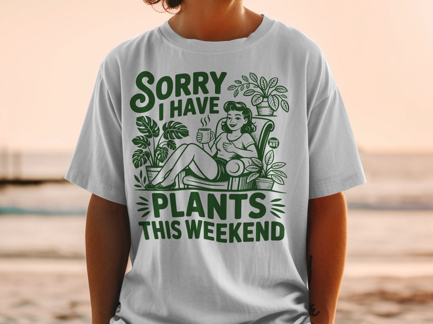 Green t-shirt with "Sorry I Have Plants This Weekend" text and woman with plants.