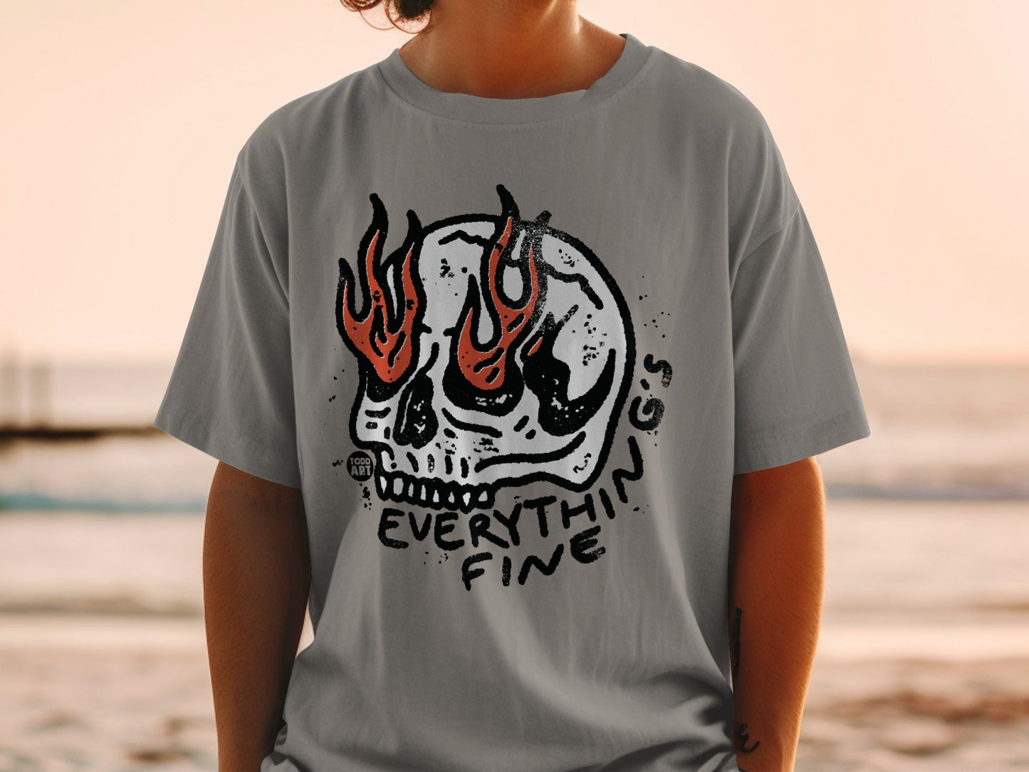 Skull with flames and "EVERYTHING FINE" text on a gray t-shirt.