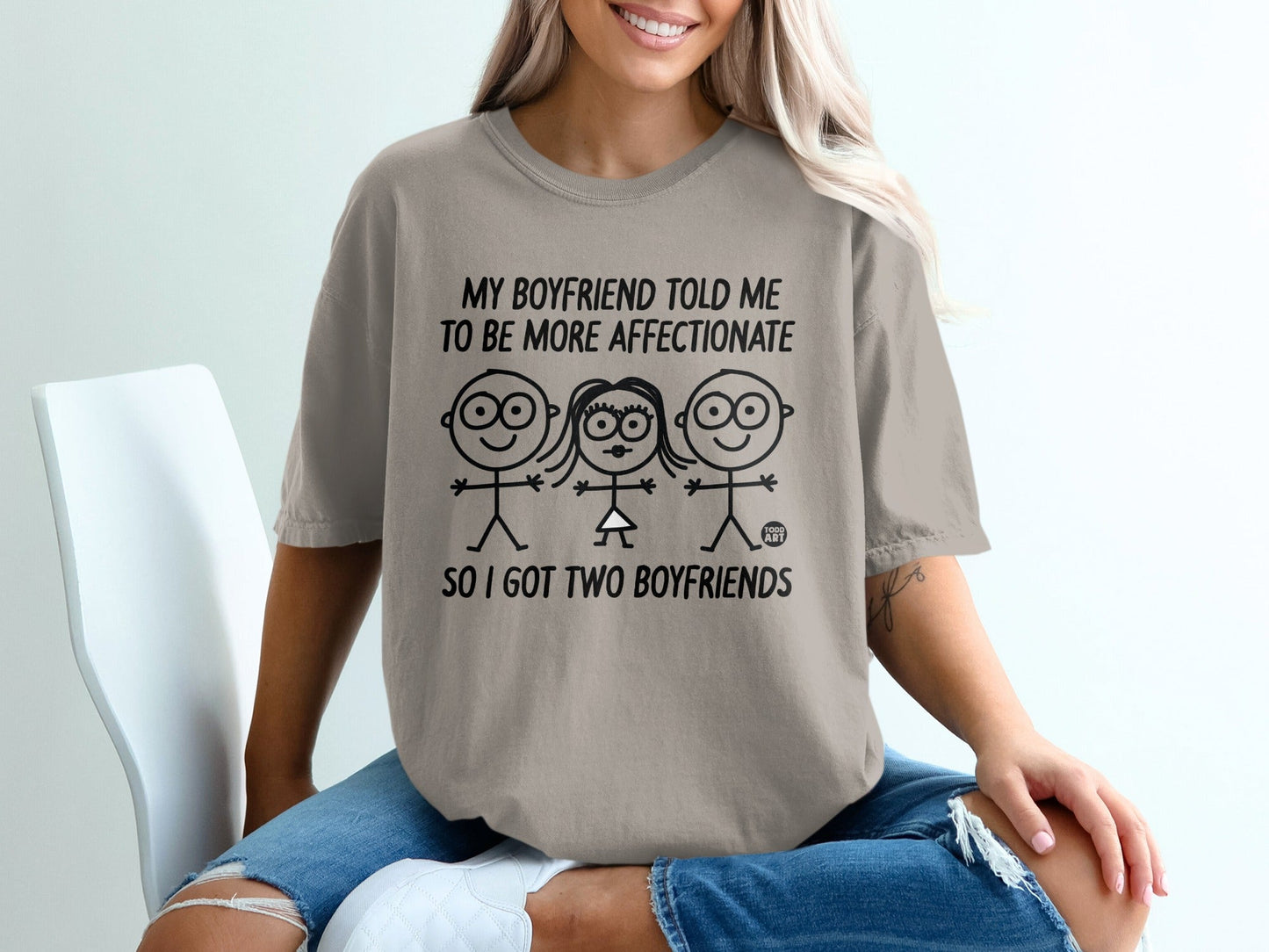 T-shirt with cartoon figures and text: "My boyfriend told me to be more affectionate, so I got two boyfriends."