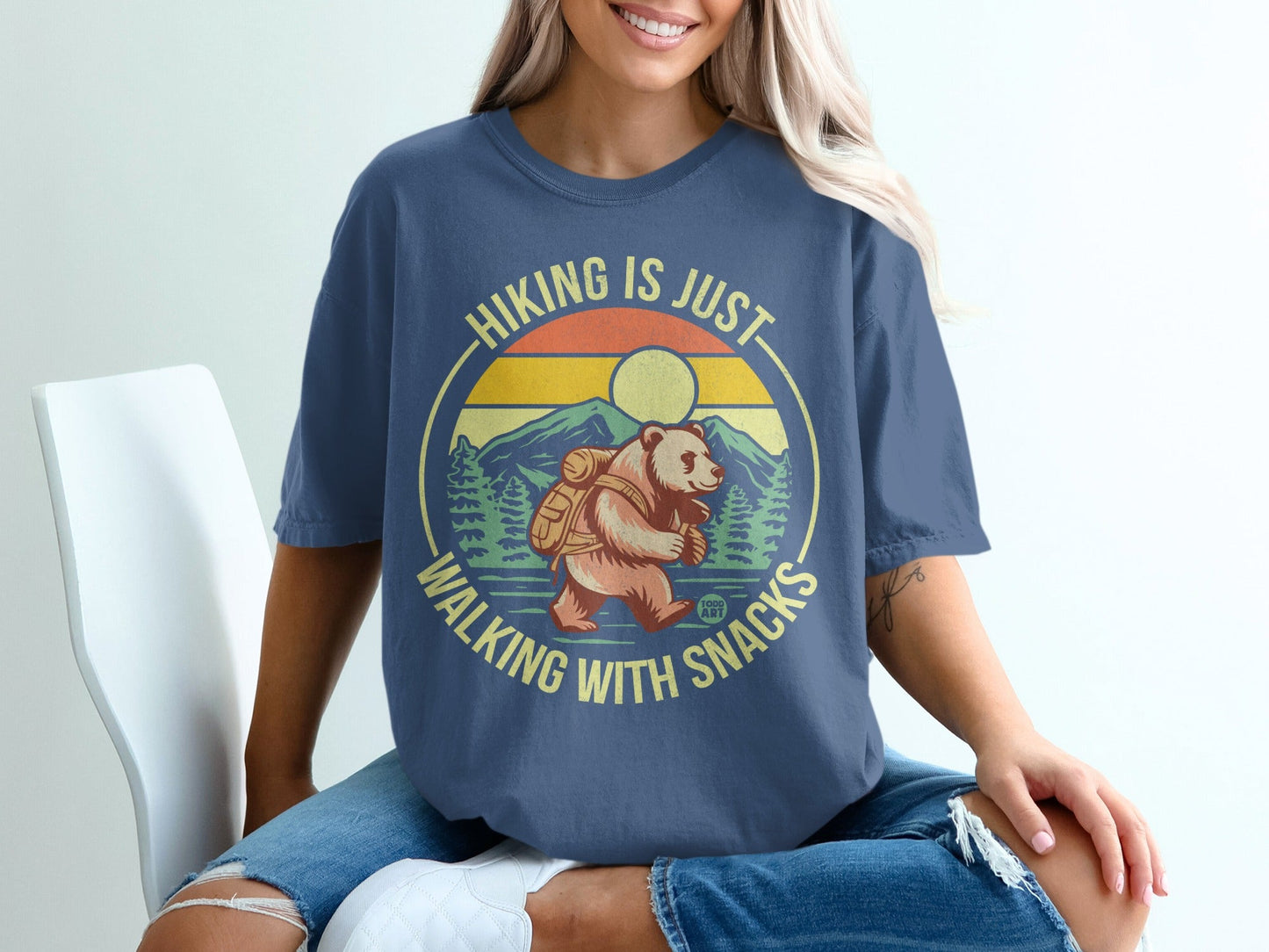 Blue t-shirt with bear hiking graphic and text "Hiking is just walking with snacks."