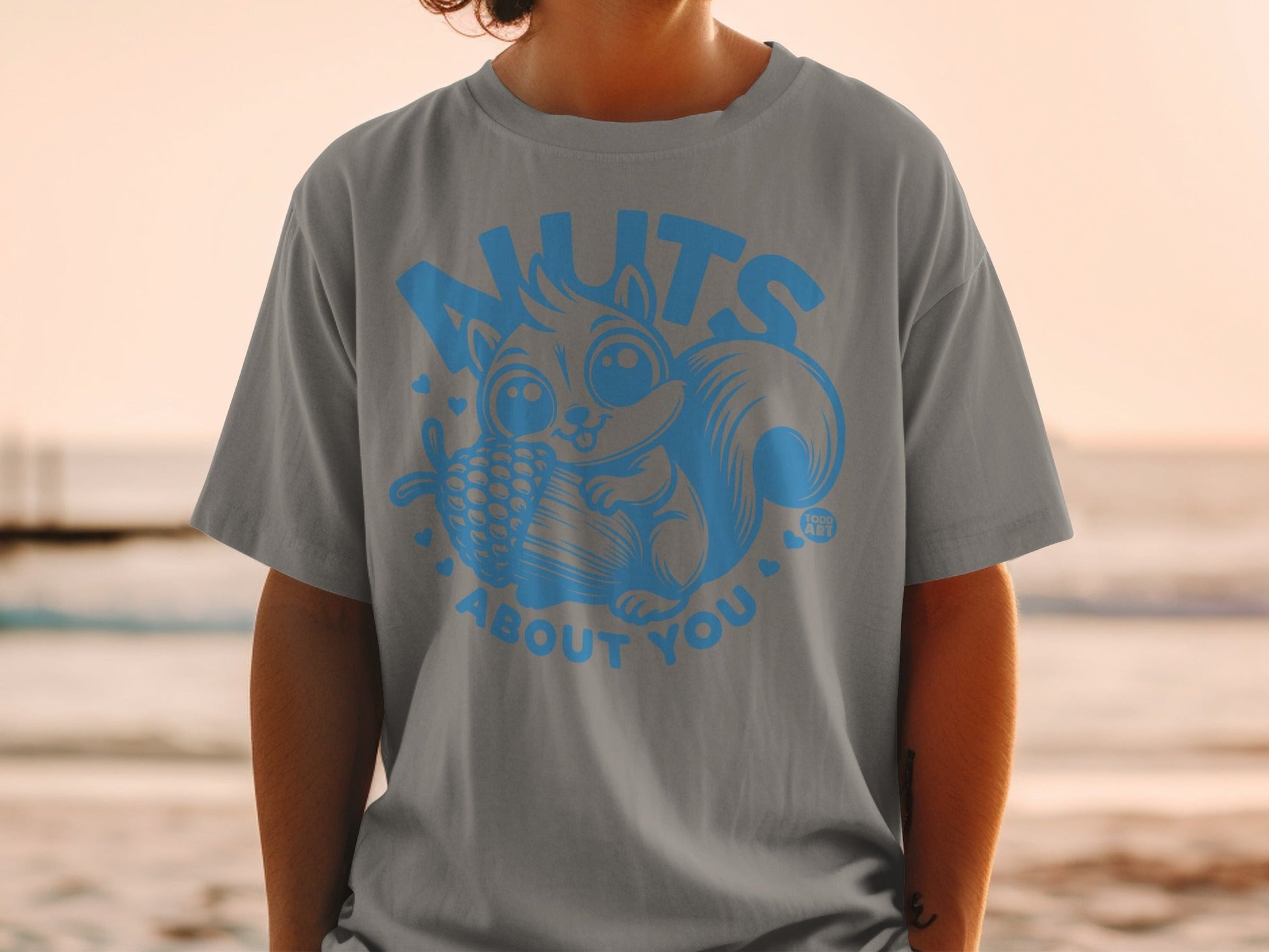 Squirrel graphic on a gray t-shirt with "nuts about you" text.
