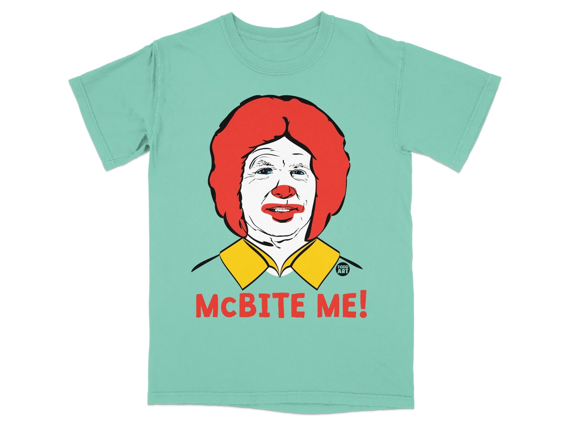 Mint green t-shirt featuring a graphic of Ronald McDonald with "MCBITE ME!" text.