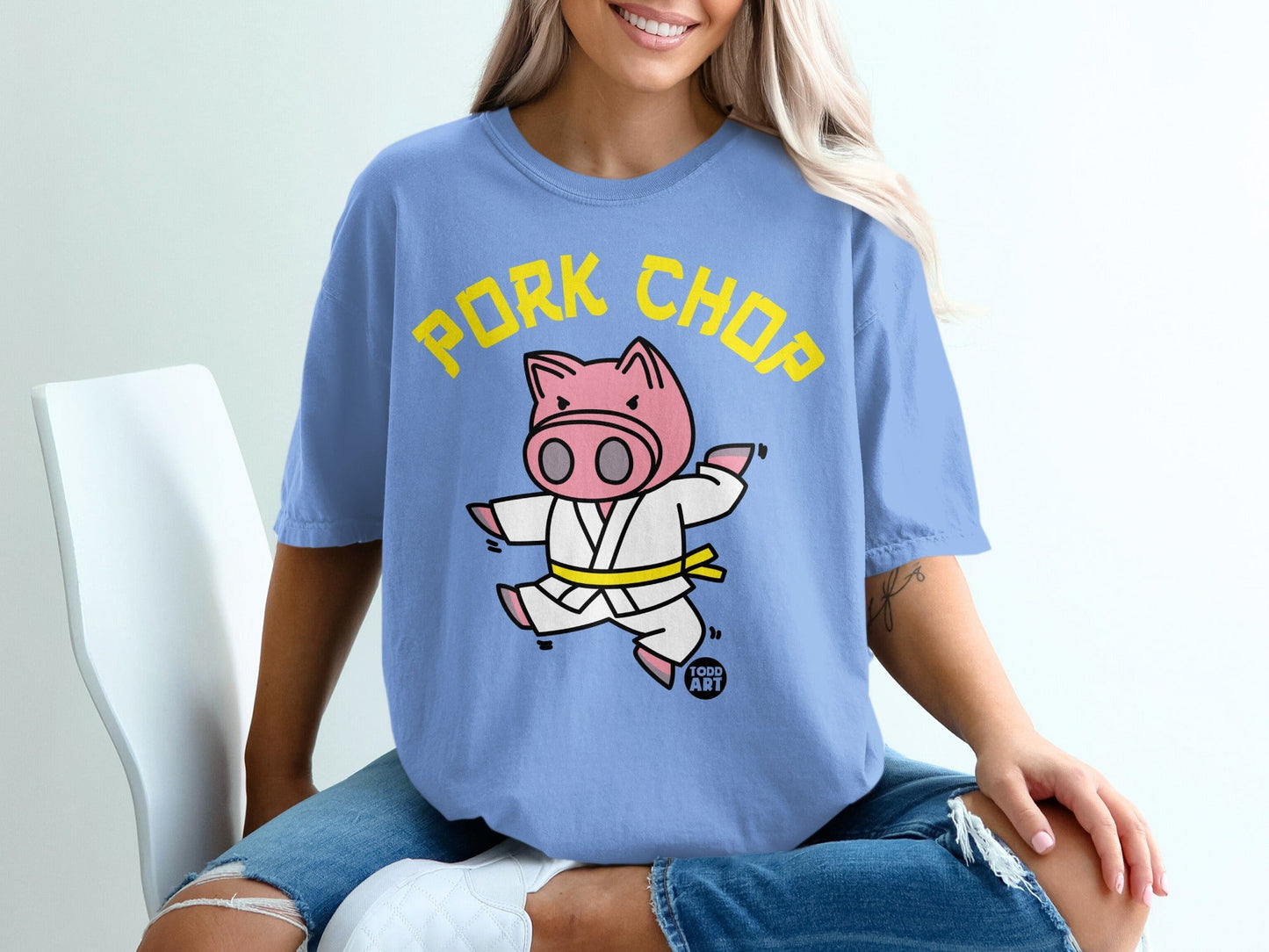 Light blue t-shirt with "PORK CHOP" text and a cartoon pig in a karate gi.