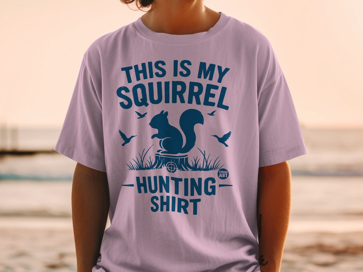 Lilac t-shirt with a squirrel graphic and "This is my squirrel hunting shirt" text.