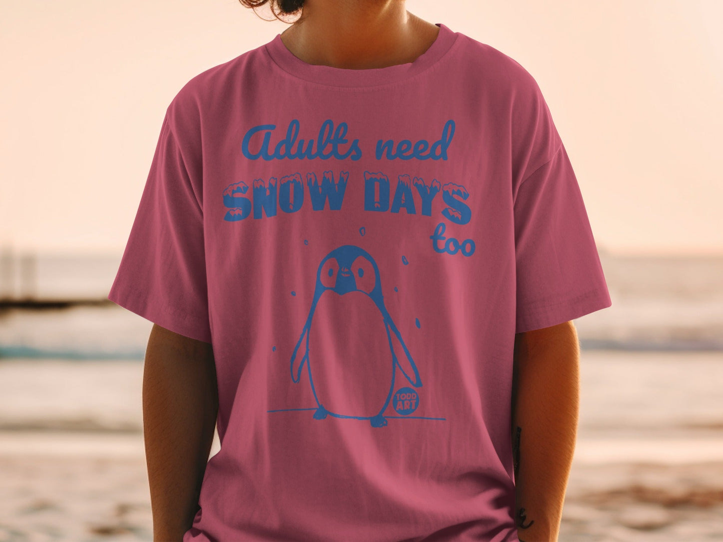 Pink t-shirt with "Adults need SNOW DAYS too" and penguin graphic.