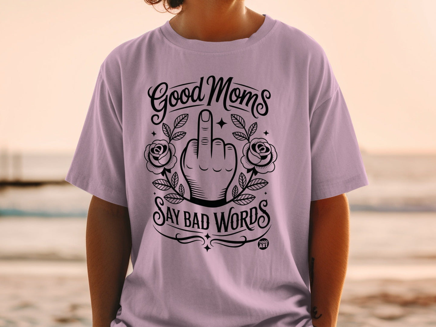 Light purple t-shirt with "Good Moms Say Bad Words" and middle finger graphic.