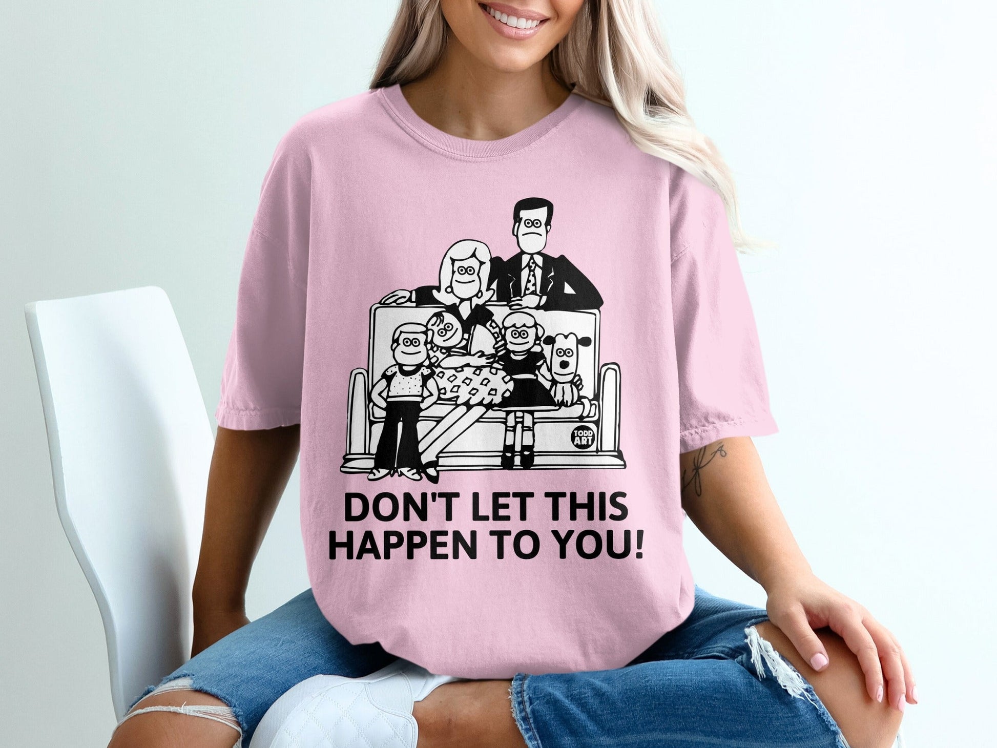 Pink t-shirt with family playing video games graphic and "DON'T LET THIS HAPPEN TO YOU!"