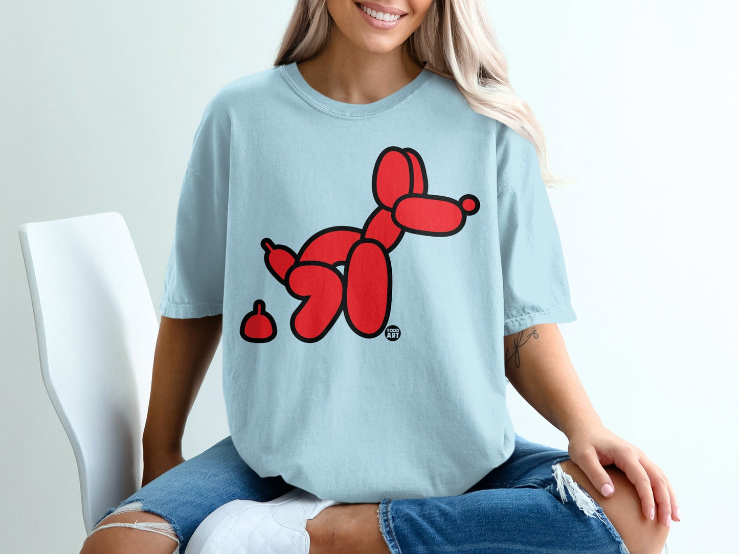 Light blue t-shirt with red balloon dog graphic and small red splat.