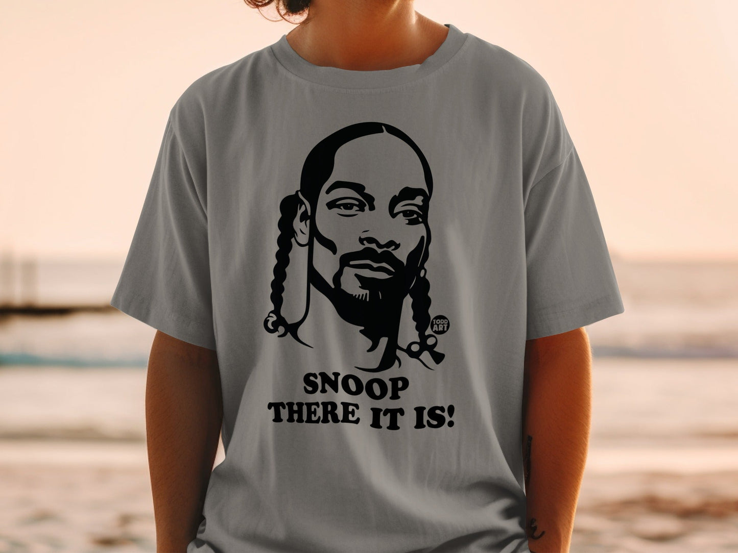 Grey t-shirt with Snoop Dogg graphic and "SNOOP THERE IT IS!" text.