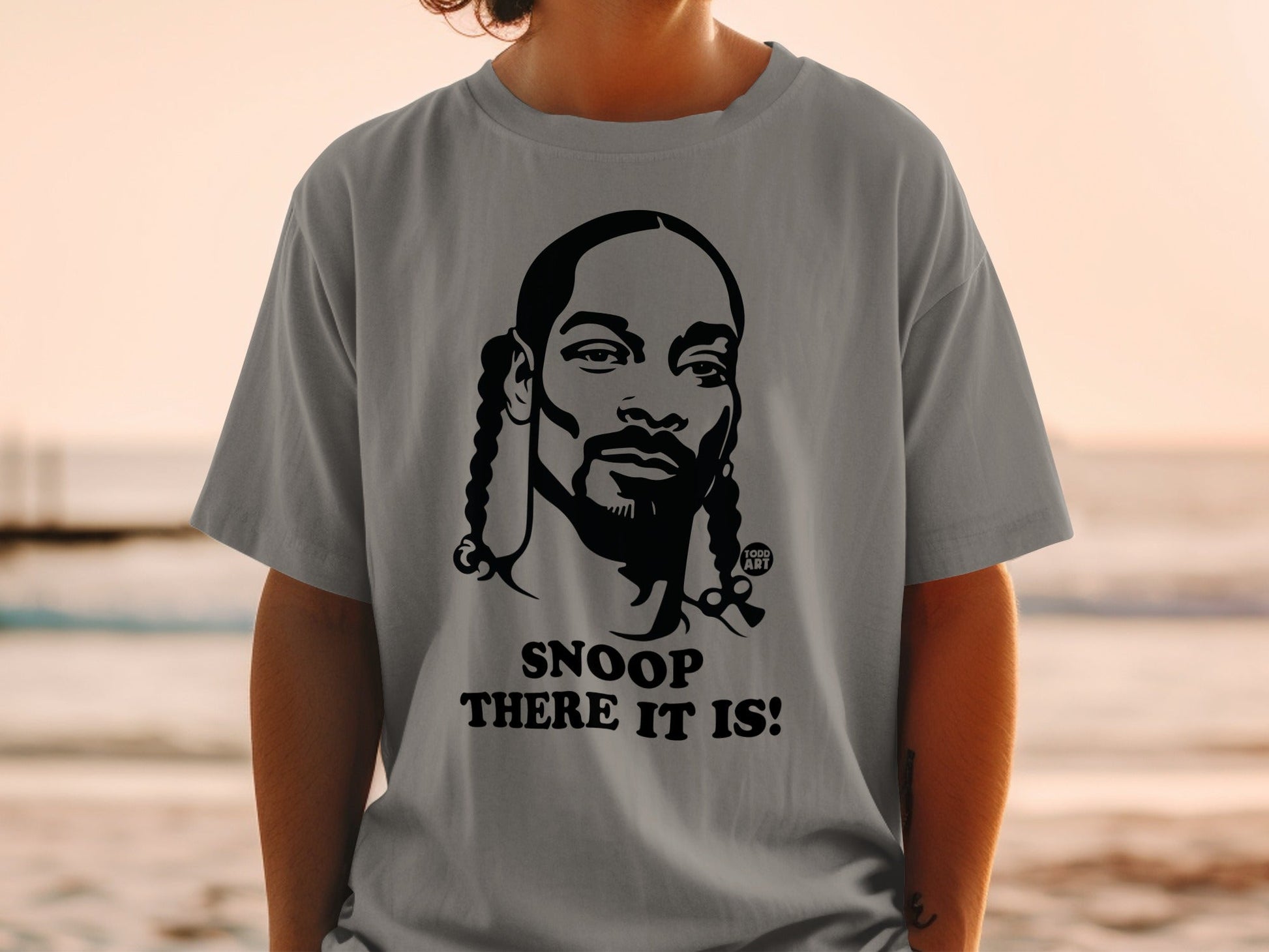 Grey t-shirt with Snoop Dogg graphic and "SNOOP THERE IT IS!" text.