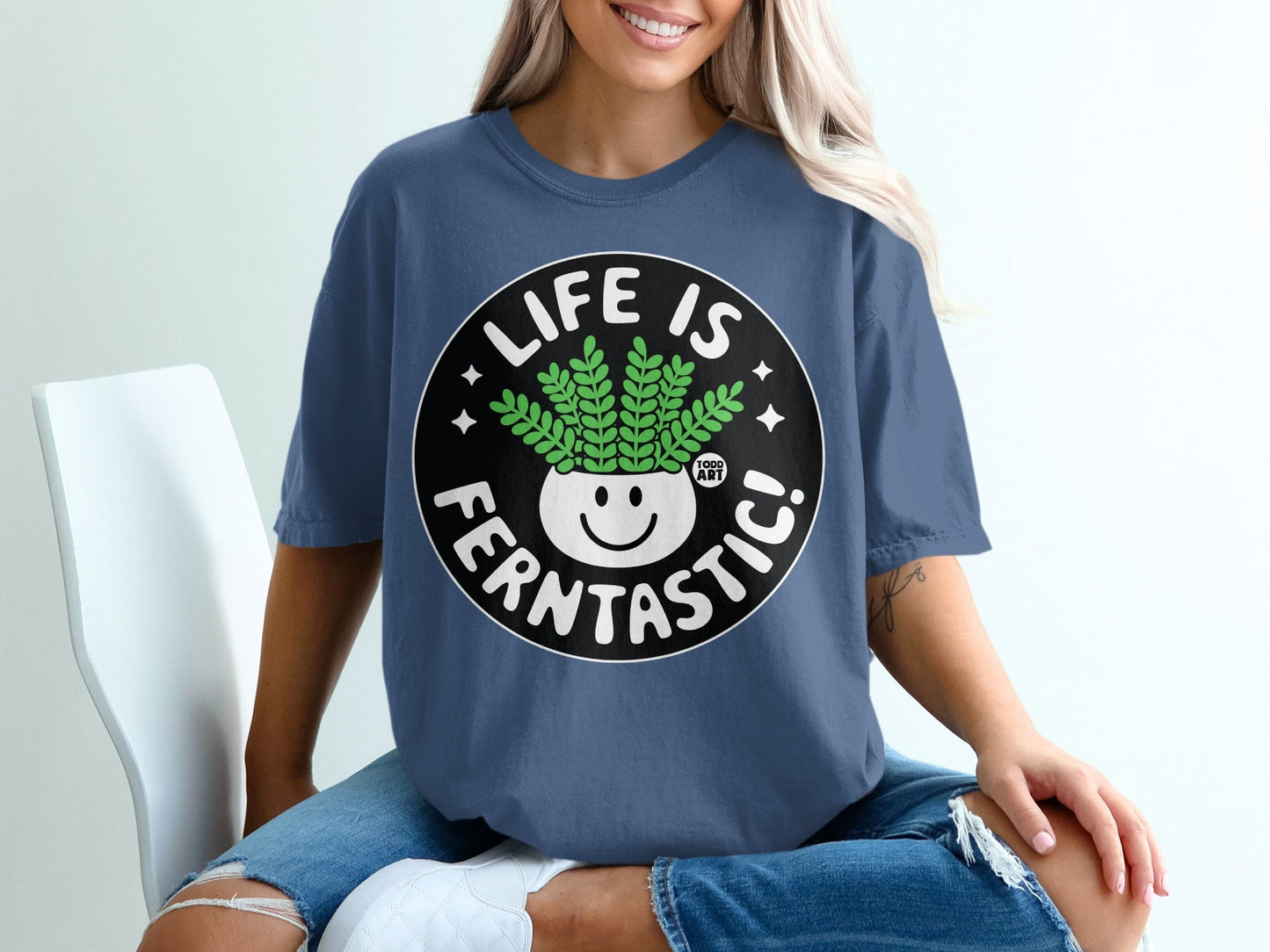 T-shirt with "Life is Ferntastic!" text and smiling potted fern graphic.