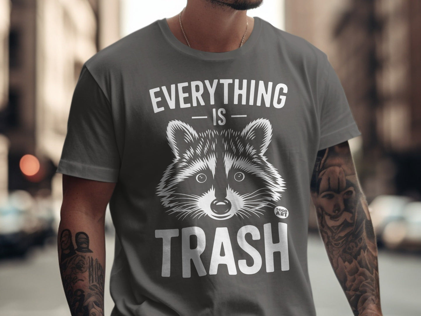 Gray t-shirt with a raccoon graphic and text "Everything is Trash."