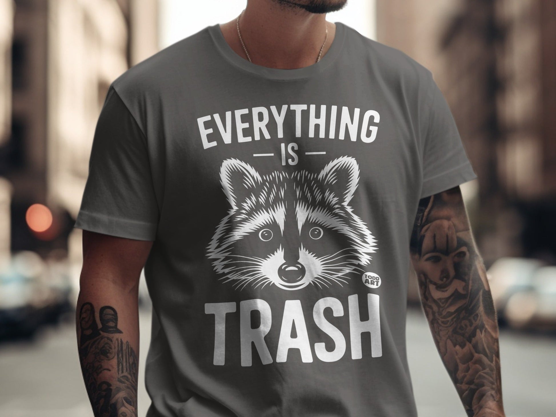 Gray t-shirt with a raccoon graphic and text "Everything is Trash."