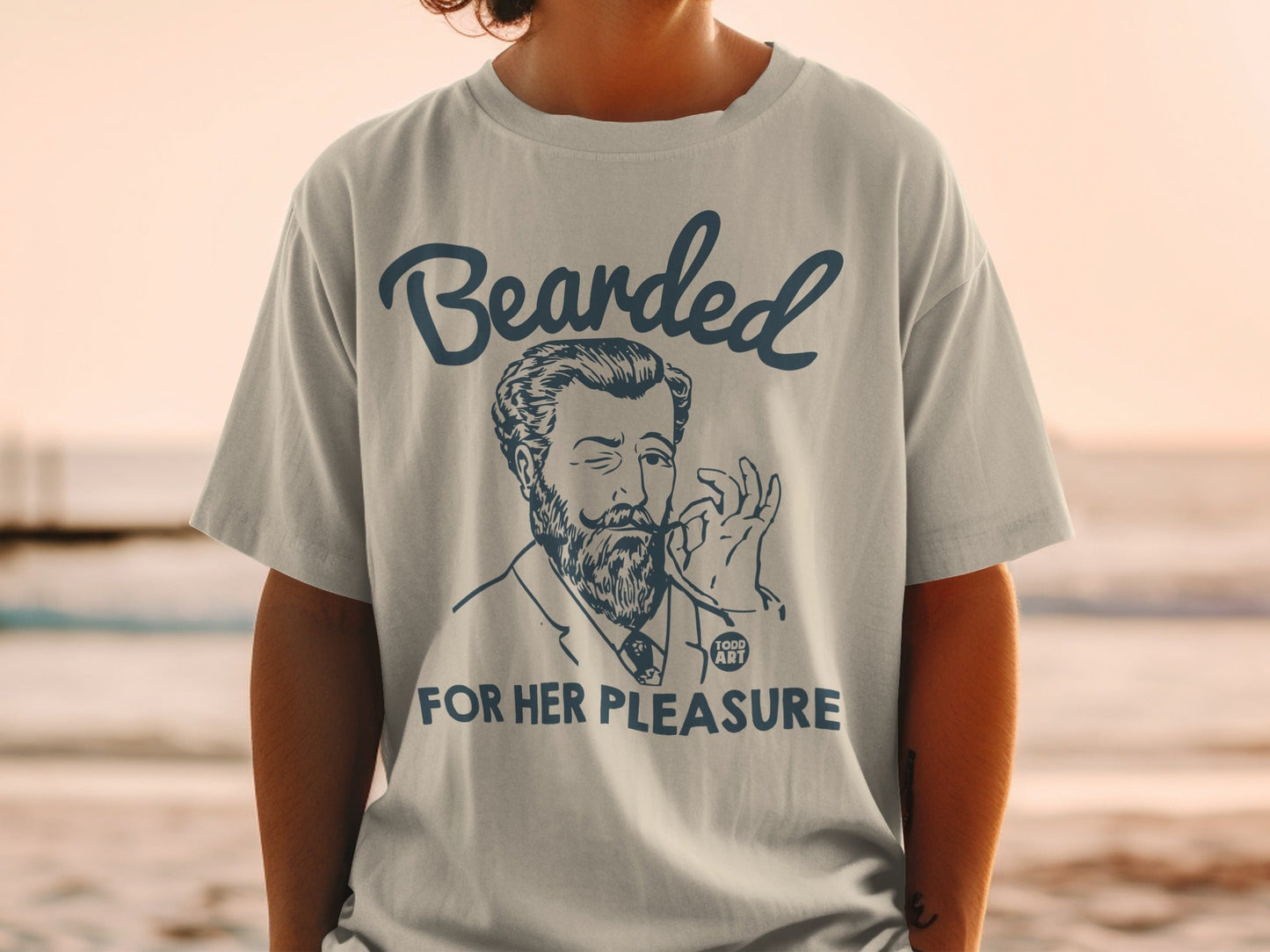 Gray t-shirt with "Bearded For Her Pleasure" text and drawing of a man.