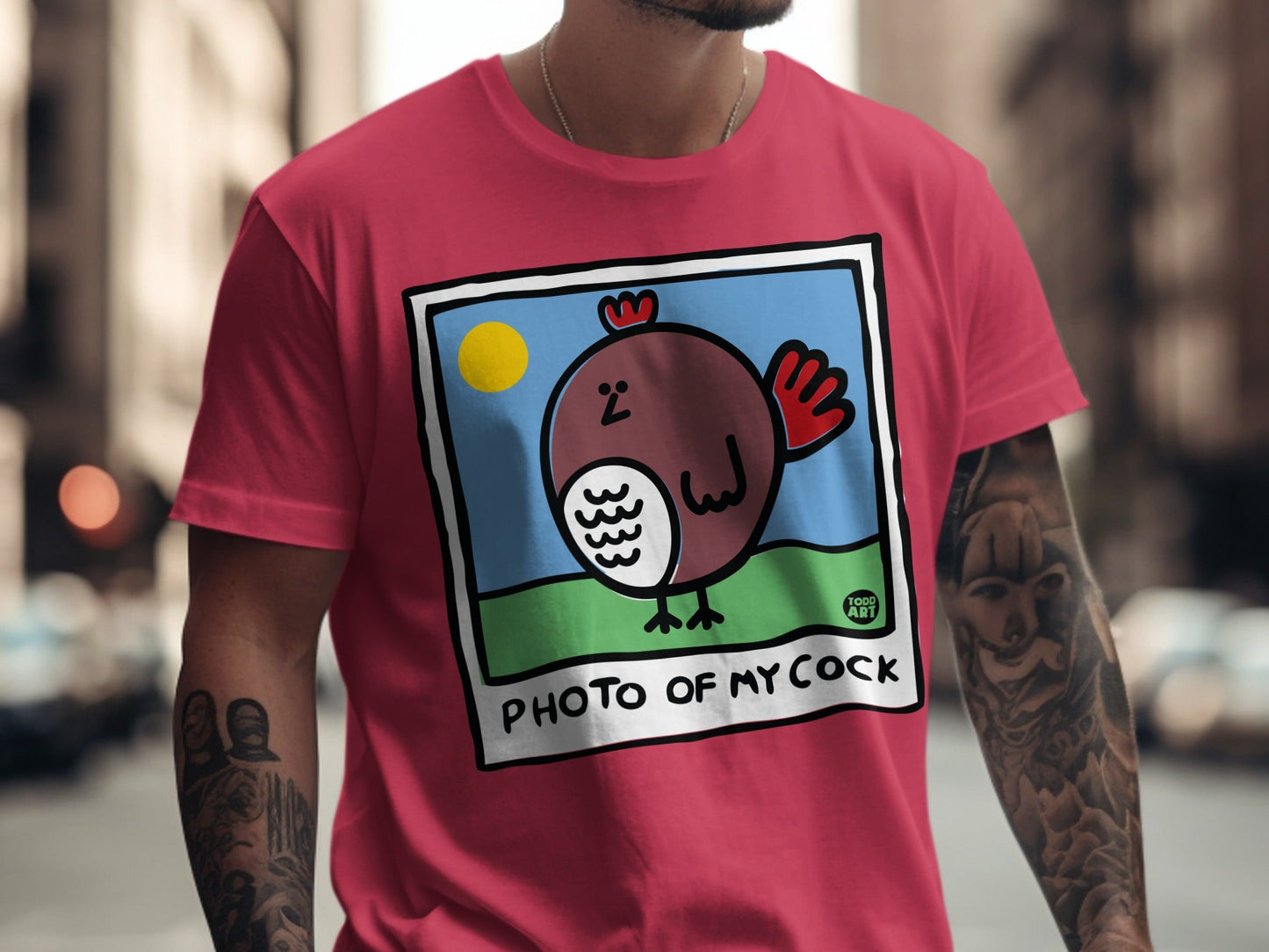 T-shirt with cartoon chicken on a blue sky background, text reads "PHOTO OF MY COCK".