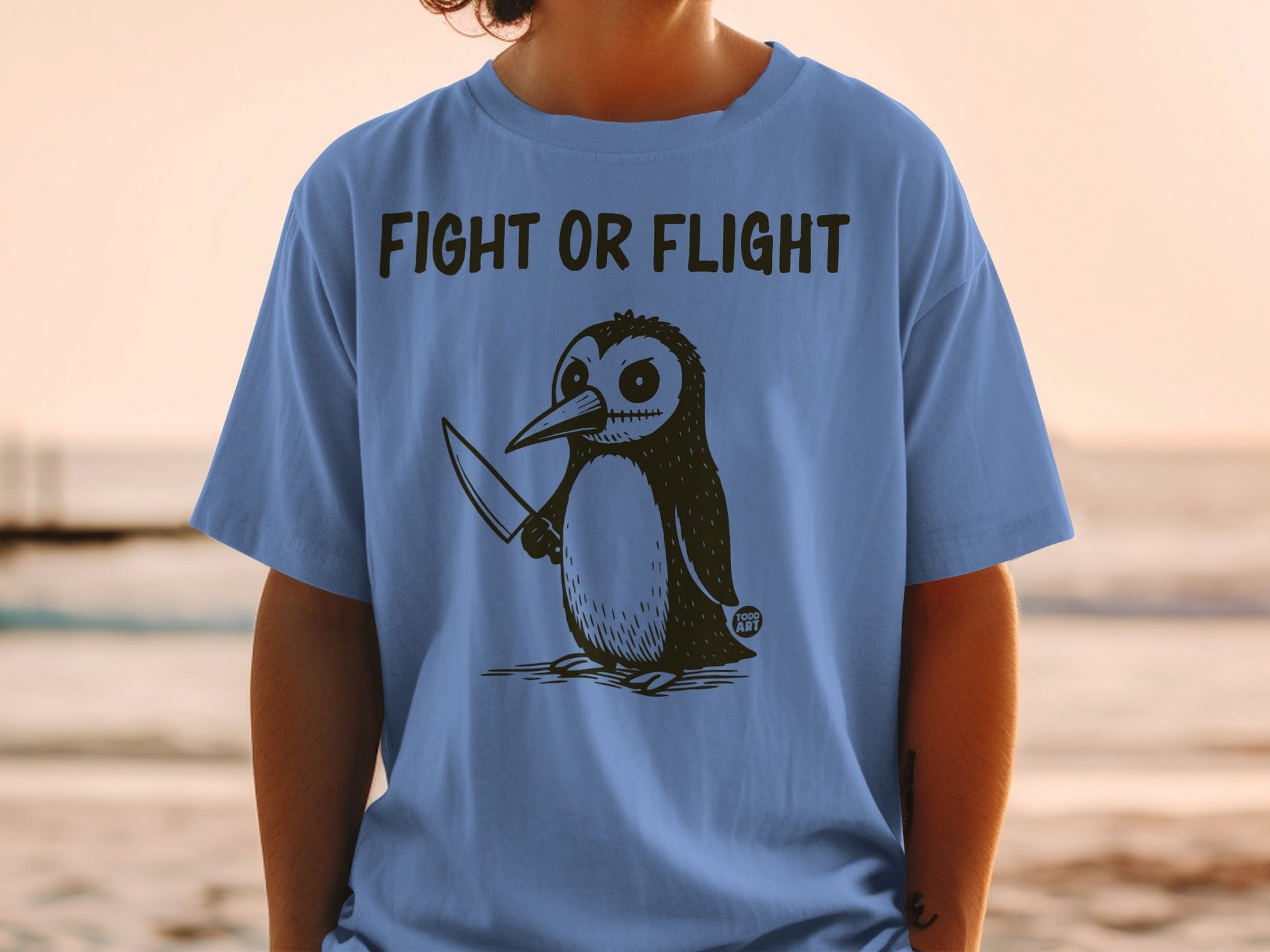 T-shirt with a drawing of a penguin holding a knife and the text "Fight or Flight".
