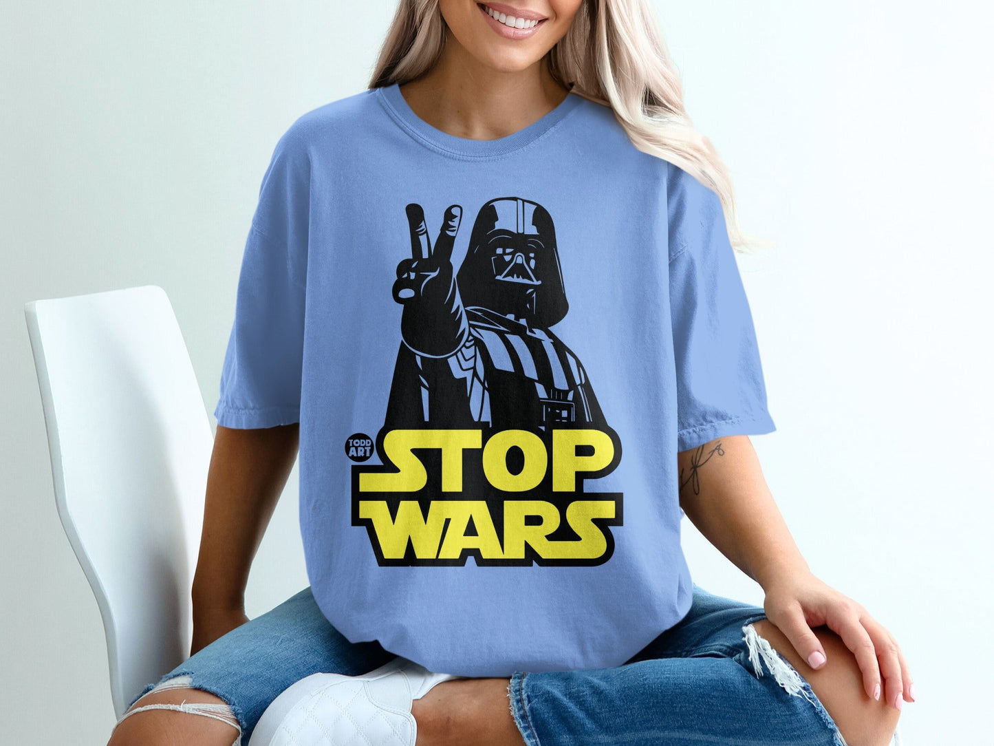 Darth Vader giving peace sign on blue t-shirt, text "STOP WARS".