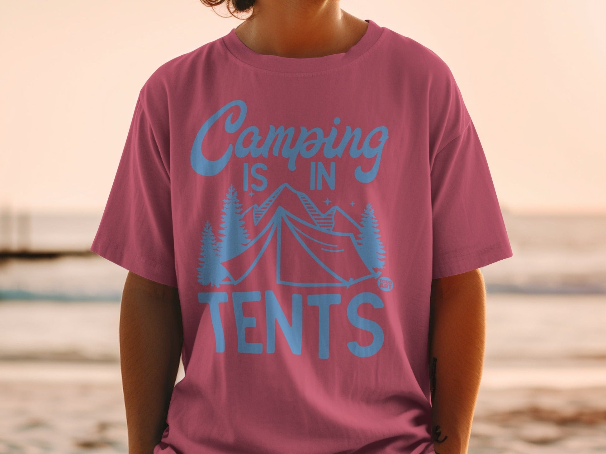 T-shirt with text "Camping is in tents" and mountain and tree graphics.
