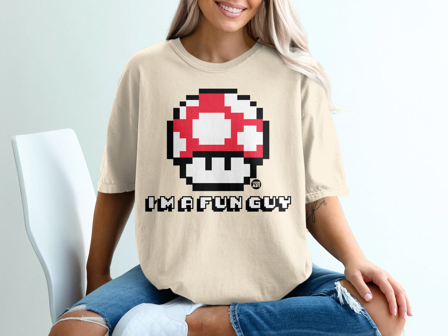 Cream t-shirt with Super Mario mushroom graphic and "I'm a fun guy" text.
