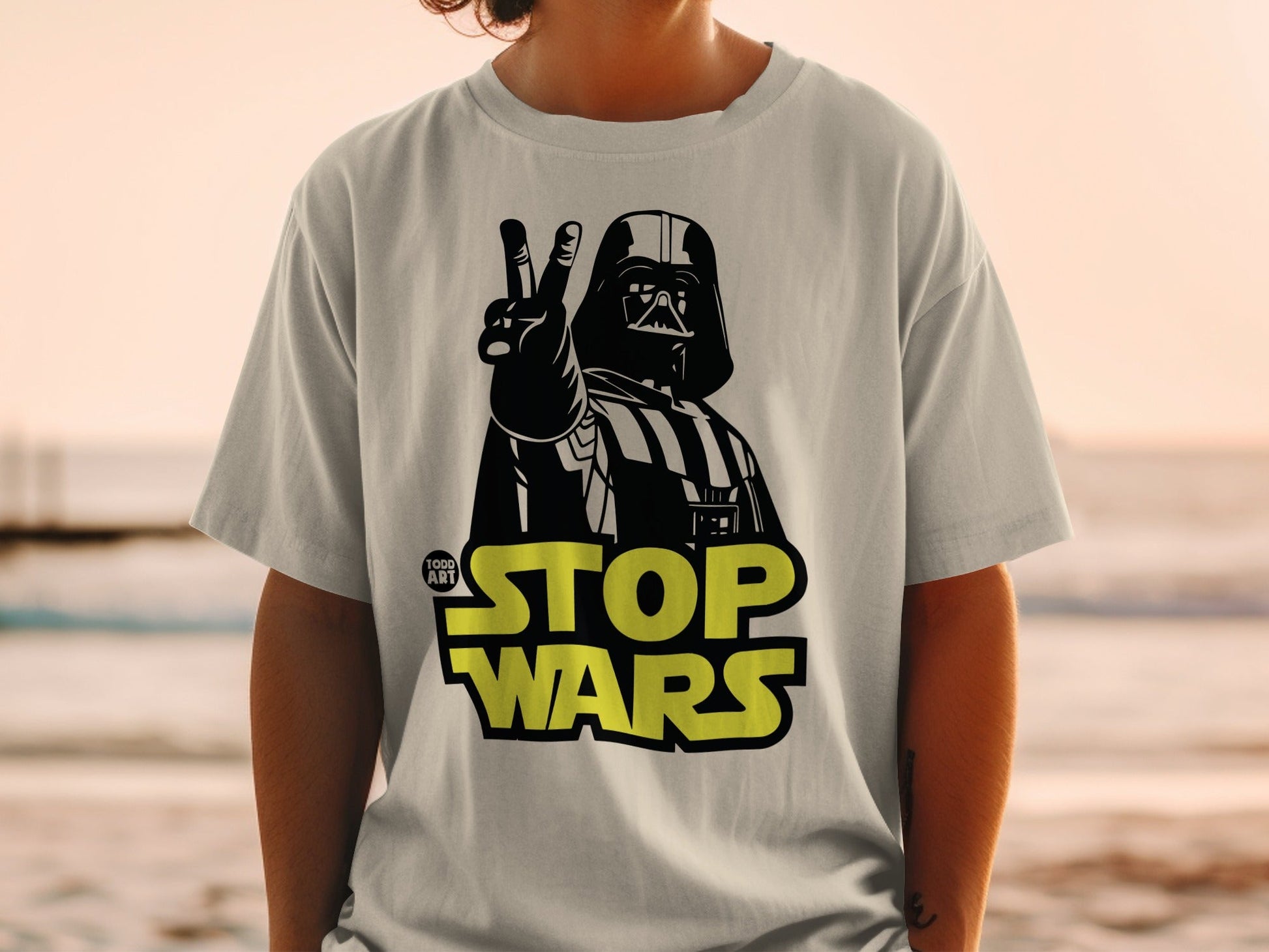 Darth Vader giving peace sign with "STOP WARS" text.