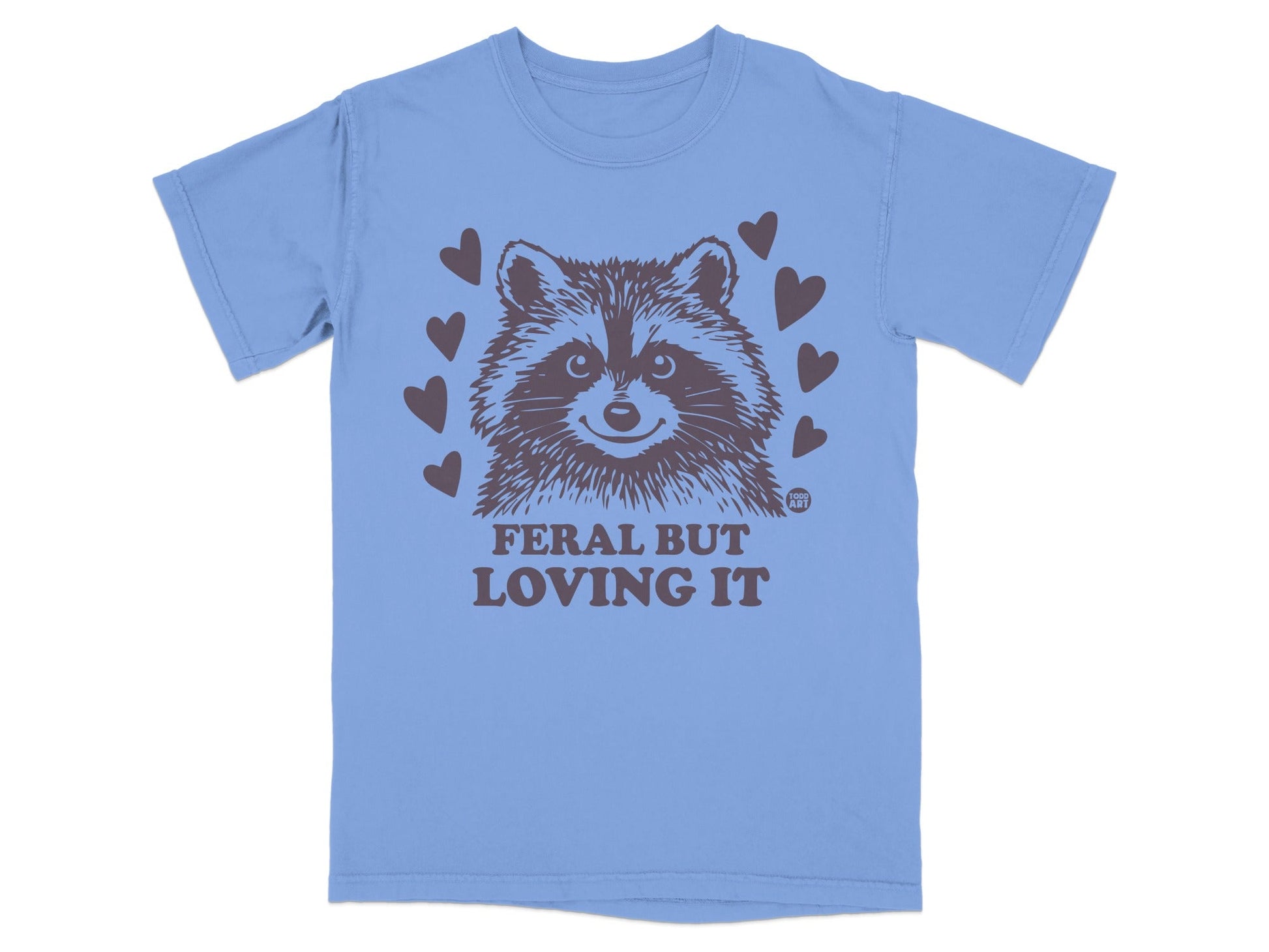 Blue t-shirt with a raccoon graphic and "FERAL BUT LOVING IT" text.