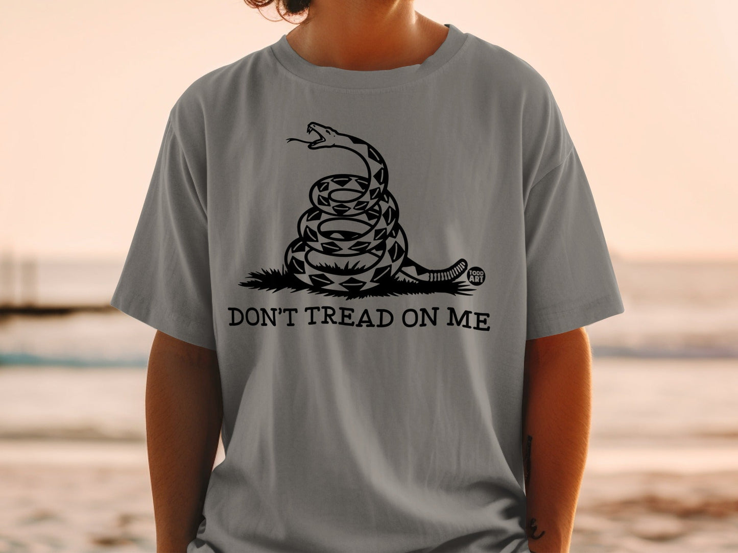 Grey t-shirt with coiled snake and "Don't Tread On Me" text.