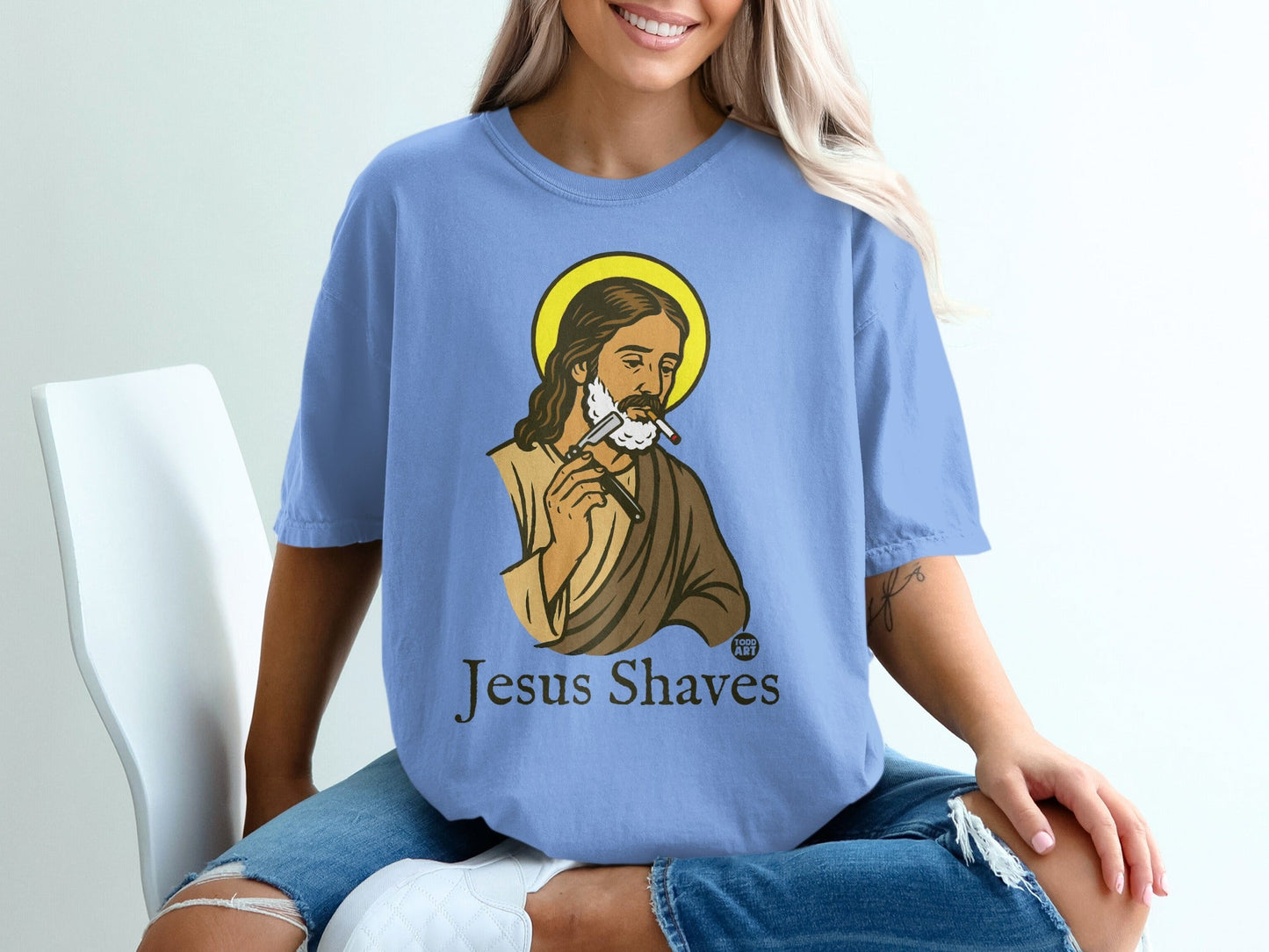 Light blue t-shirt with Jesus shaving himself, text "Jesus Shaves".