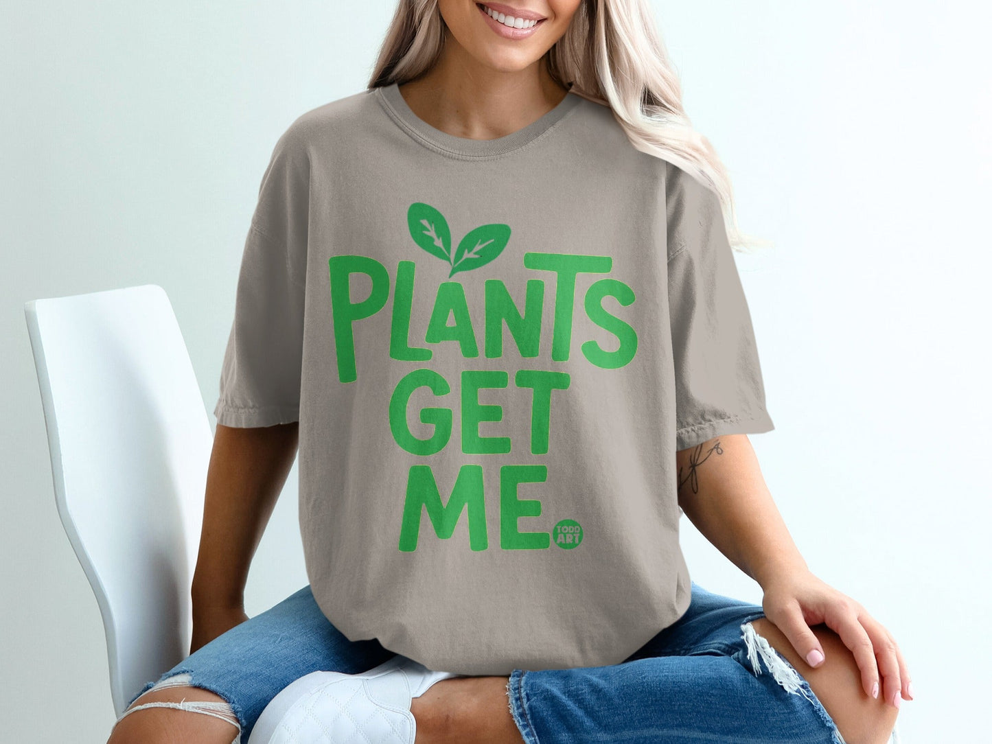 T-shirt with "PLANTS GET ME" in green lettering and leaf graphic.