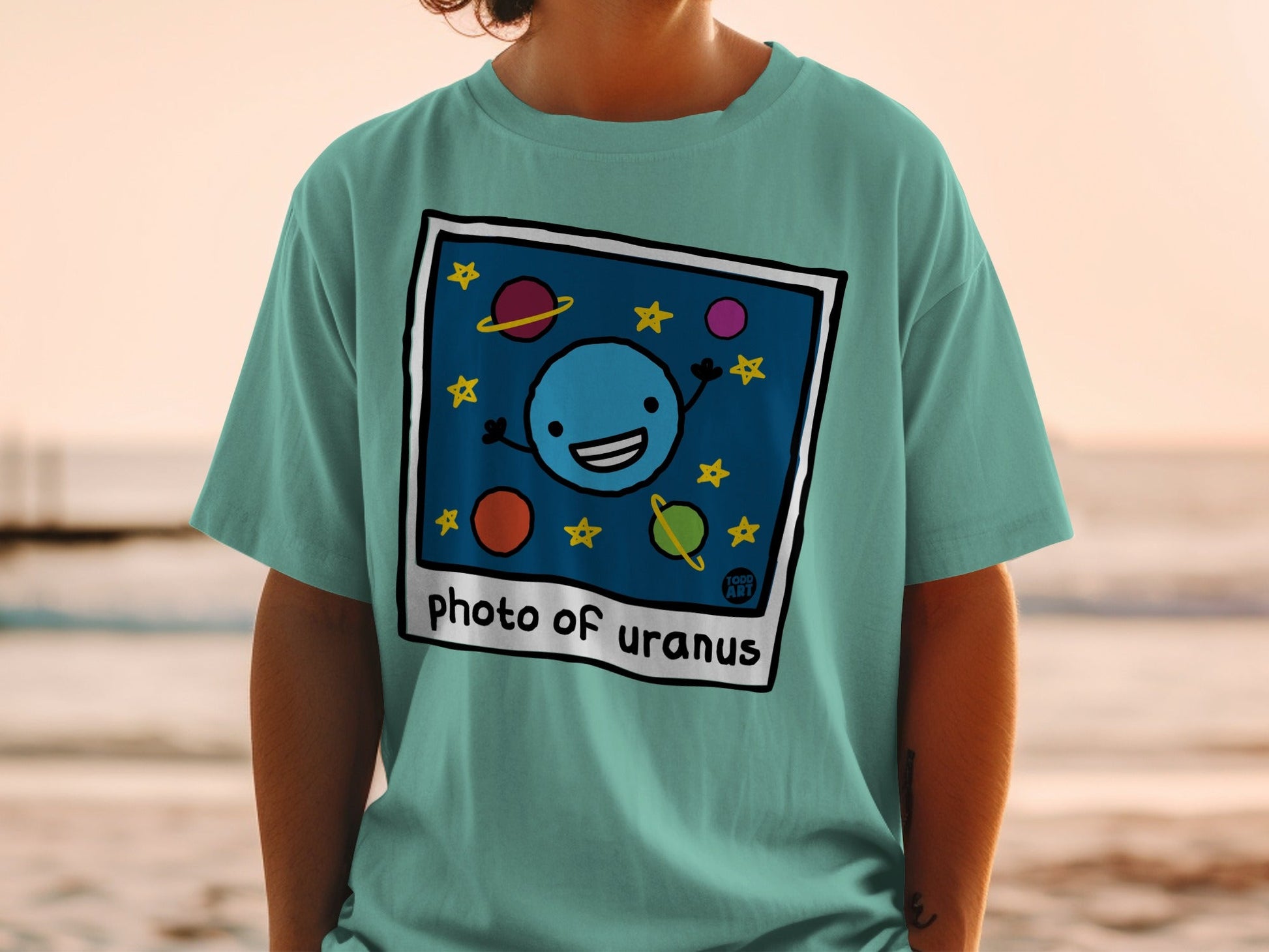T-shirt with cartoon Uranus, planets, and stars, "Photo of Uranus" text.