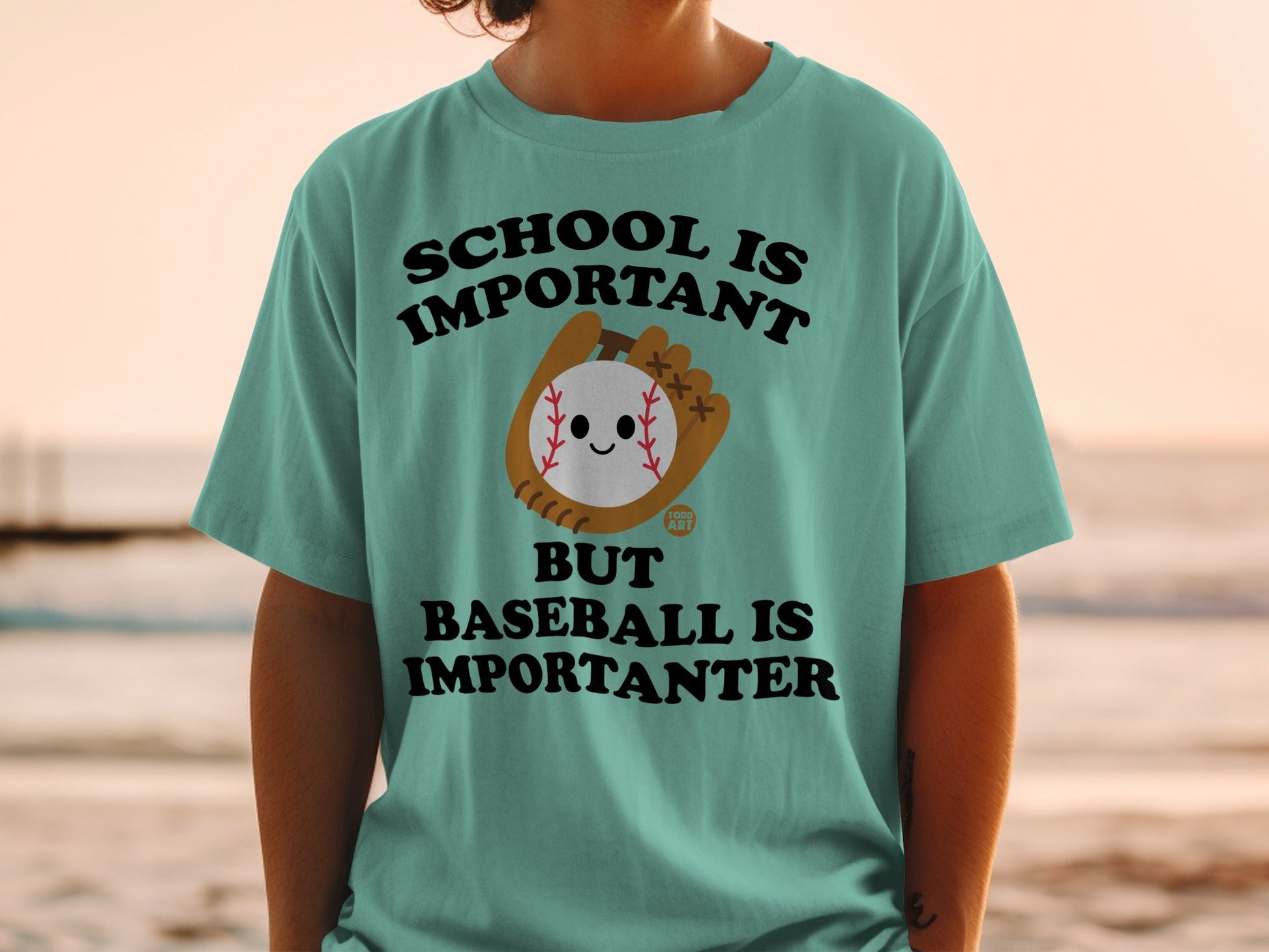 T-shirt with text "SCHOOL IS IMPORTANT BUT BASEBALL IS IMPORTANTER" and a cartoon baseball.