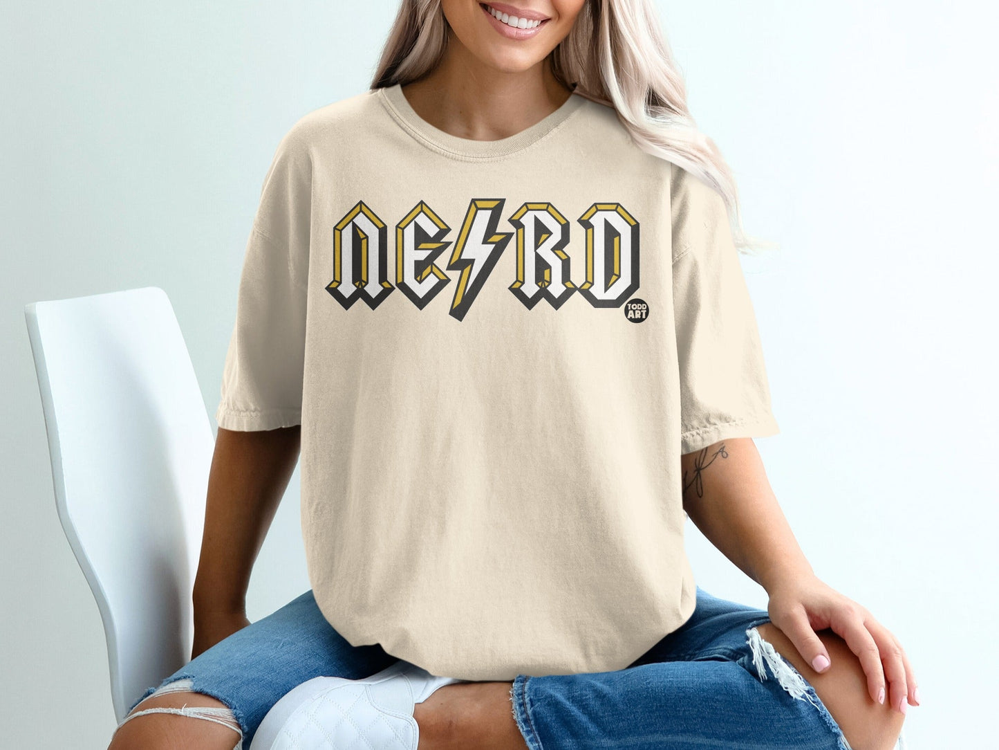 Light yellow t-shirt with "NERD" in block letters and lightning bolt graphic.