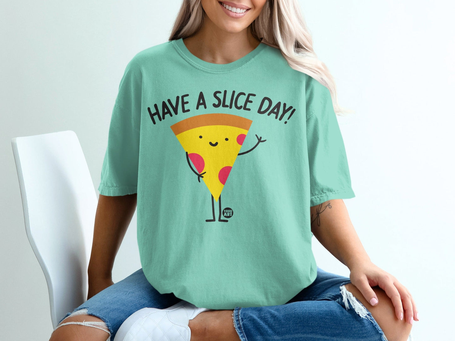 Teal t-shirt with "Have a Slice Day!" text and a smiling pizza character.