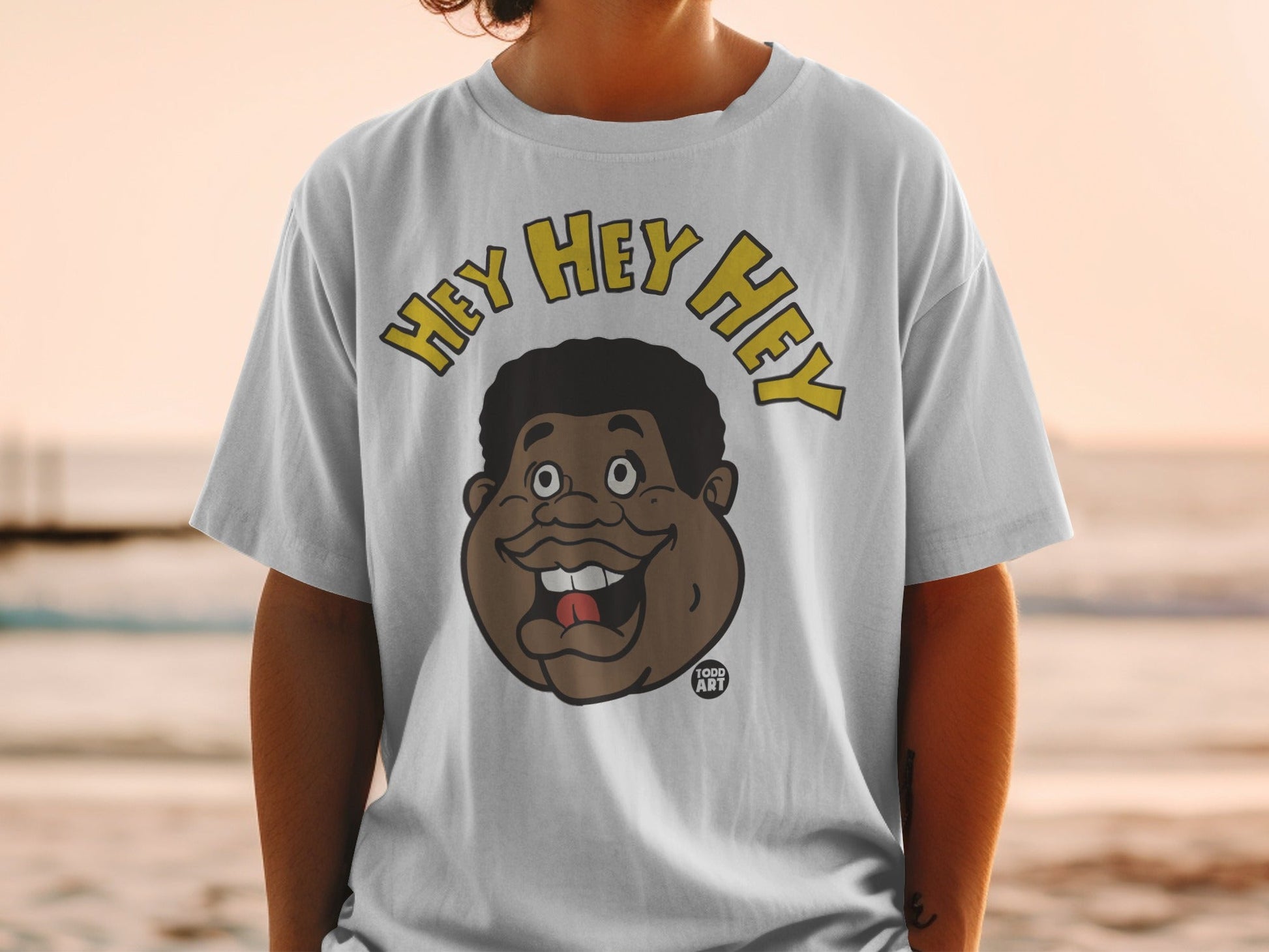 White t-shirt with cartoon man's face and "HEY HEY HEY" text.