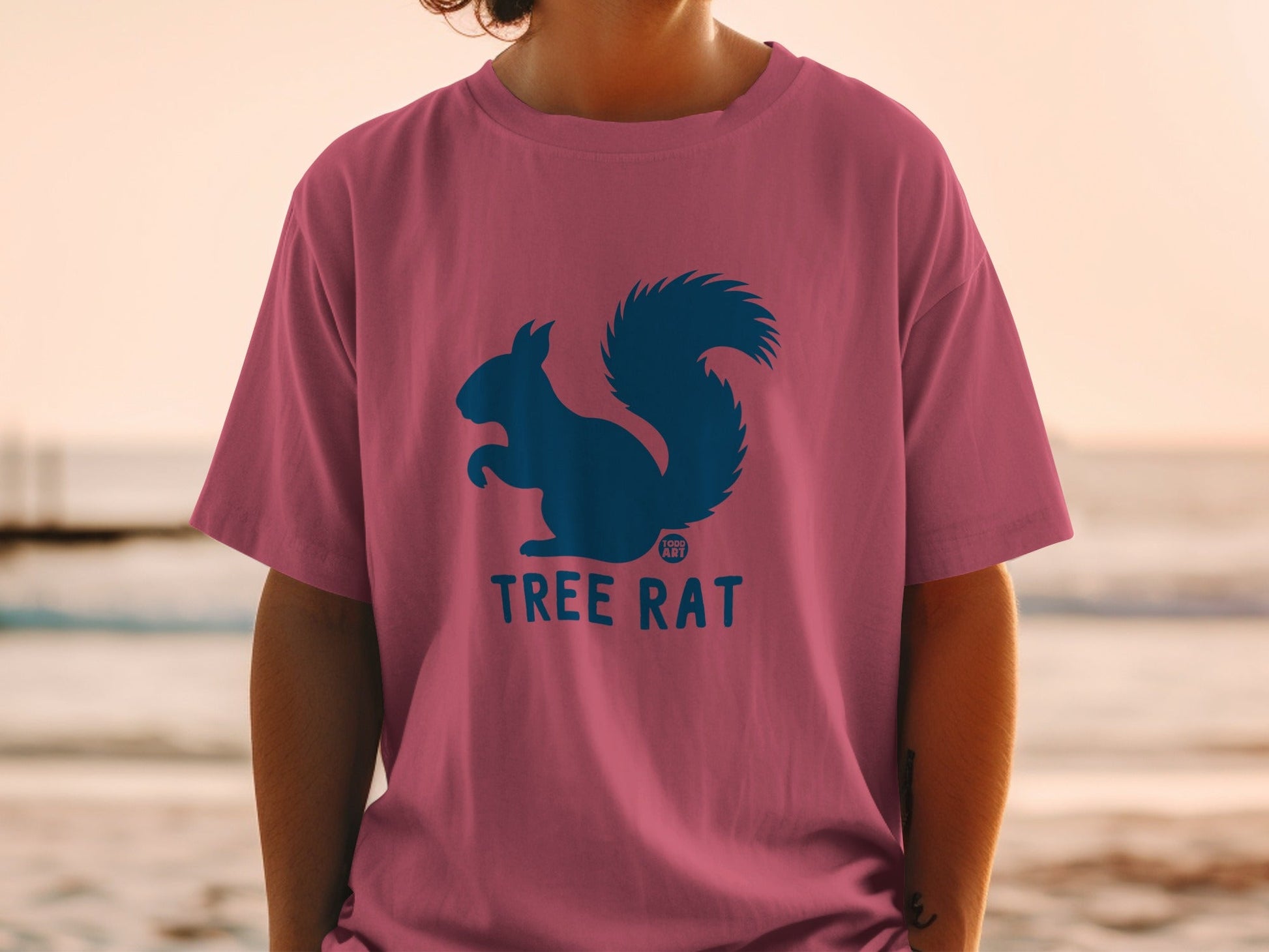 Pink t-shirt with blue squirrel logo and "Tree Rat" text.