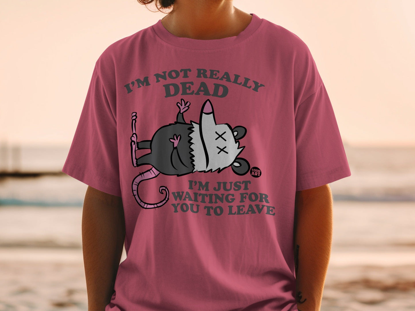 T-shirt with cartoon possum and text "I'm not really dead, I'm just waiting for you to leave".