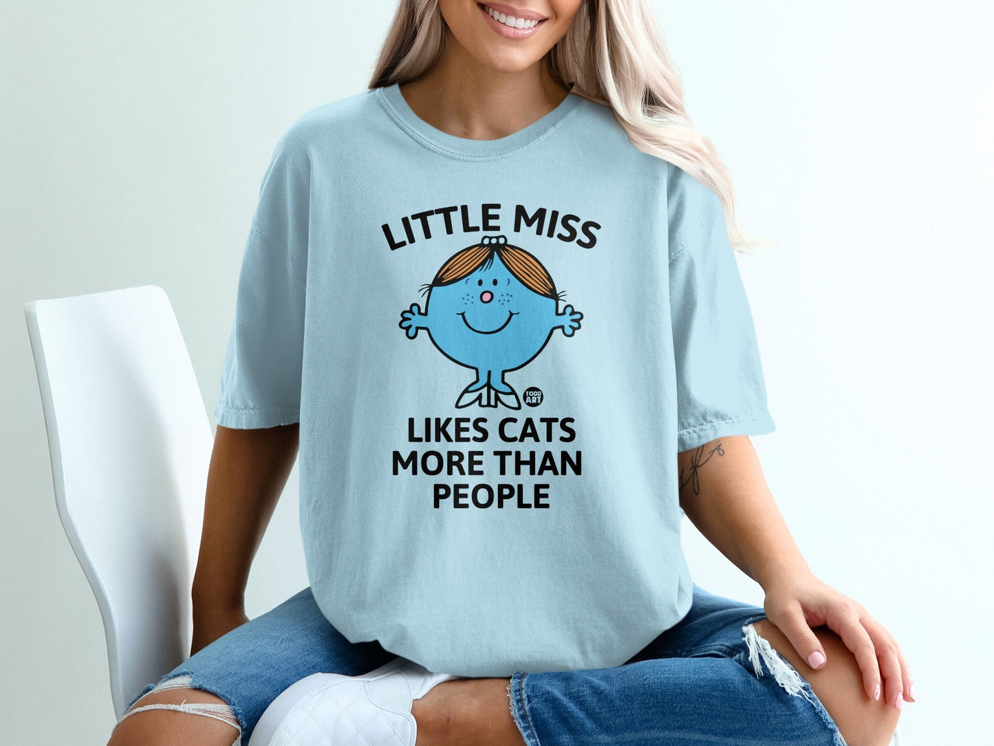 Light blue t-shirt with "Little Miss Likes Cats More Than People" text and cartoon cat character.