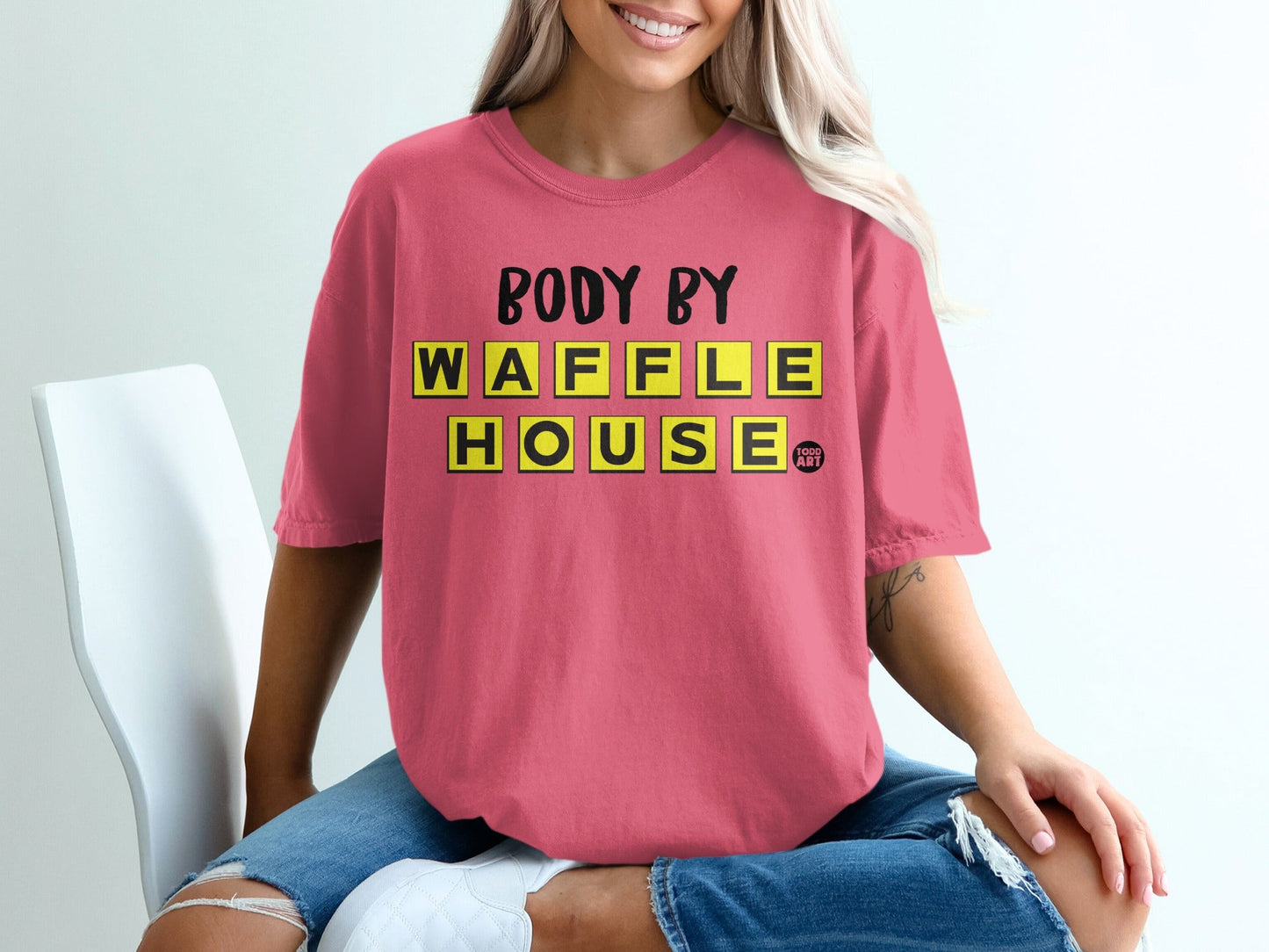 Pink t-shirt with "BODY BY WAFFLE HOUSE" text in yellow block letters.