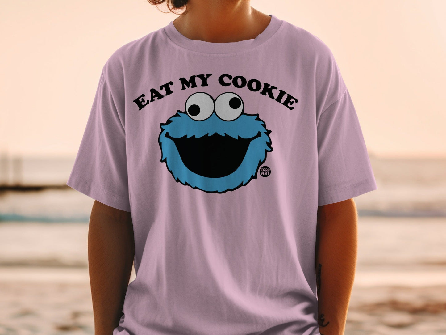 Purple t-shirt with Cookie Monster graphic and "EAT MY COOKIE" text.