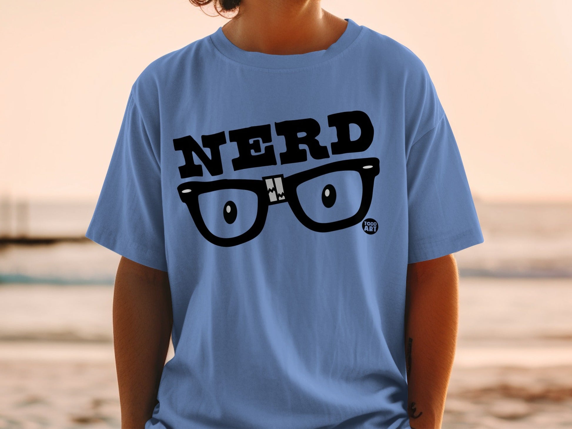 Blue t-shirt with "NERD" text and cartoon glasses graphic.