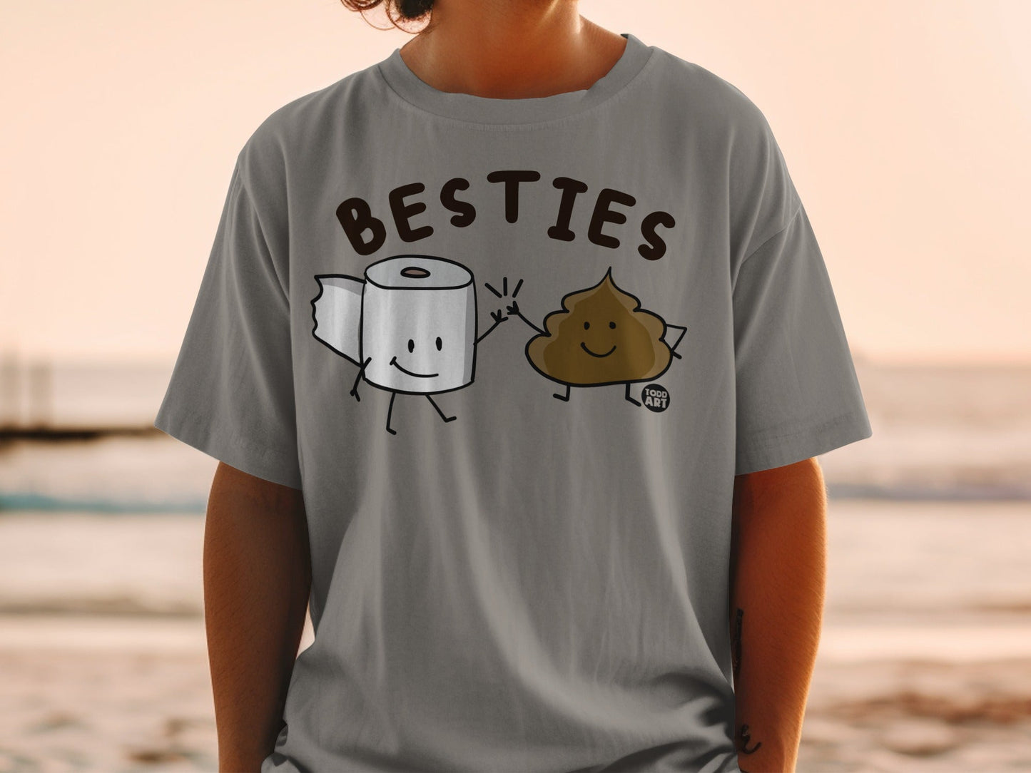 T-shirt with cartoon toilet paper and poop characters high-fiving.