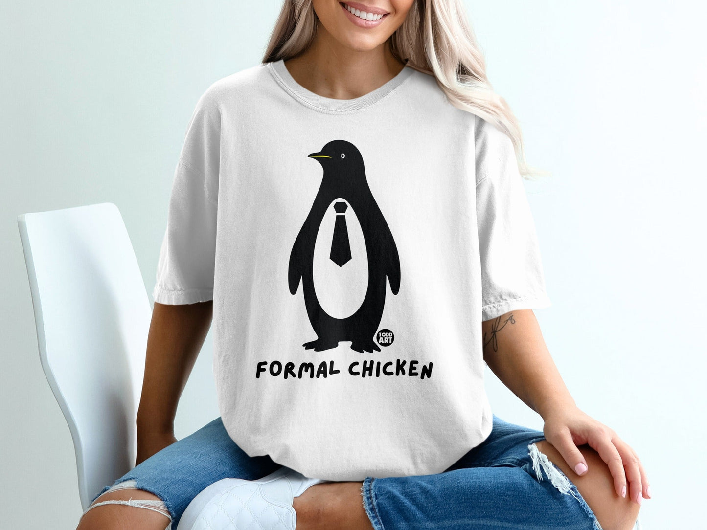 White t-shirt with a penguin wearing a tie and the text "FORMAL CHICKEN".
