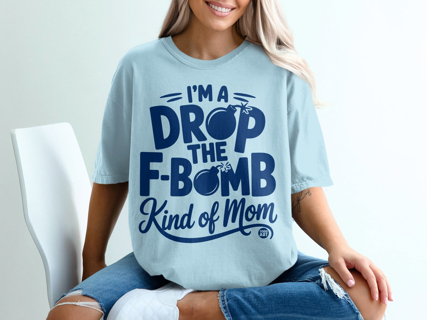 Light blue t-shirt with "I'm a drop the bomb kind of mom" graphic.