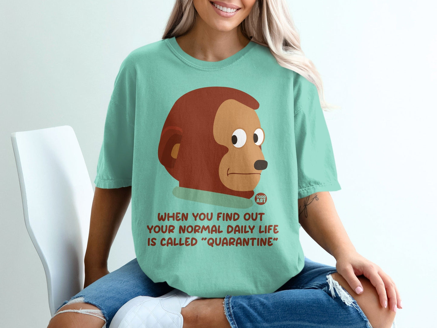 Teal t-shirt with monkey graphic and "Quarantine" text.